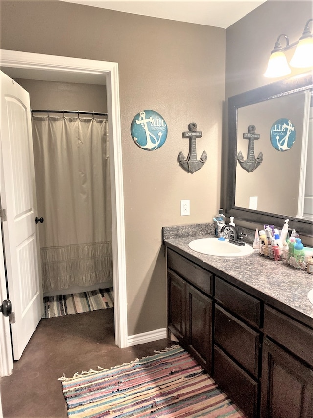 bathroom featuring curtained shower and vanity