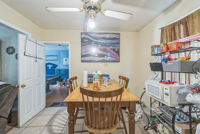 dining room with light tile patterned floors and ceiling fan