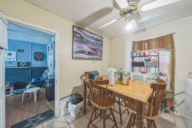 dining area featuring wood-type flooring and ceiling fan