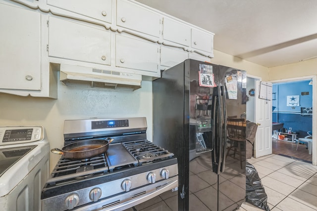 kitchen featuring black refrigerator with ice dispenser, washer / dryer, light tile patterned floors, white cabinetry, and gas range