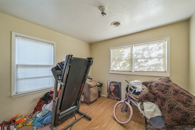 exercise room featuring light hardwood / wood-style floors