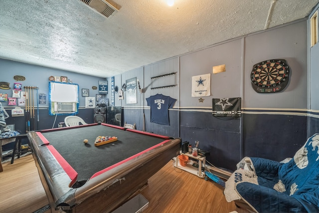 recreation room featuring a textured ceiling, cooling unit, pool table, and wood-type flooring