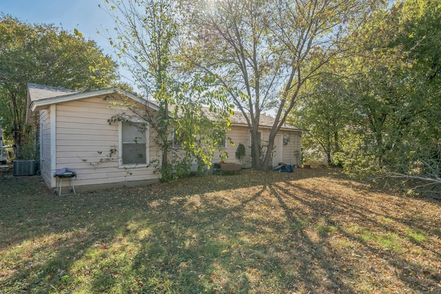 back of house featuring a yard and central AC unit