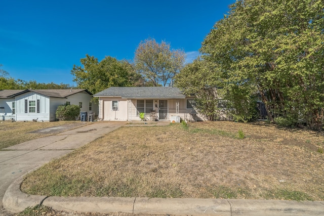 ranch-style home featuring a front yard and a porch