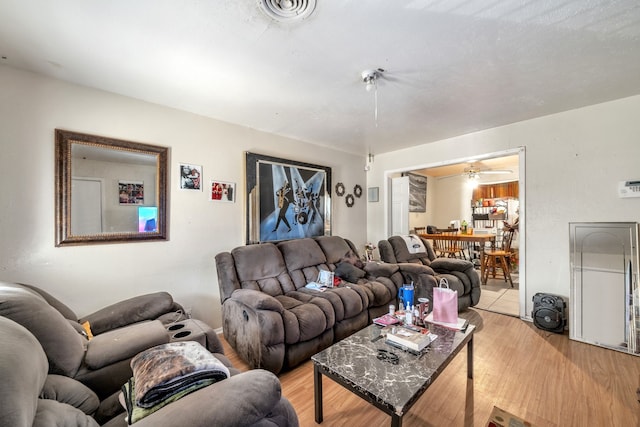 living room featuring light wood-type flooring and ceiling fan