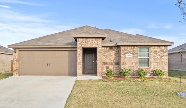 view of front of home with a garage and a front lawn