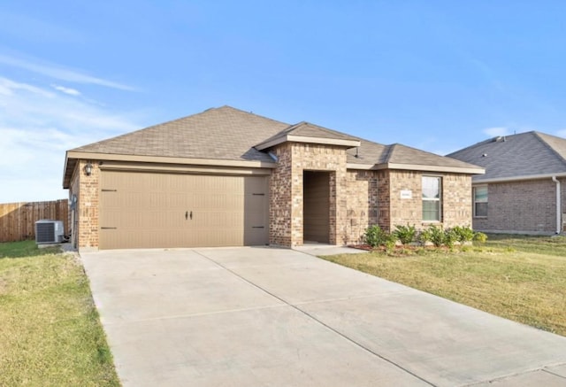 single story home featuring central air condition unit, a front lawn, and a garage