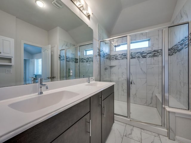 full bath featuring a healthy amount of sunlight, marble finish floor, and a sink