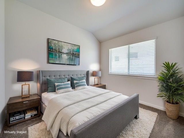 bedroom featuring vaulted ceiling, carpet flooring, and baseboards