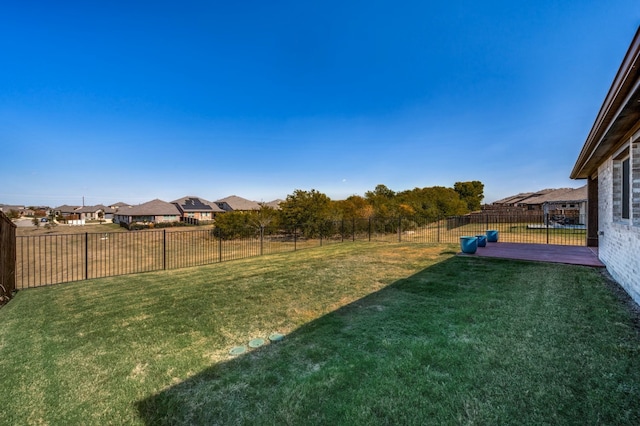 view of yard with a fenced backyard and a residential view