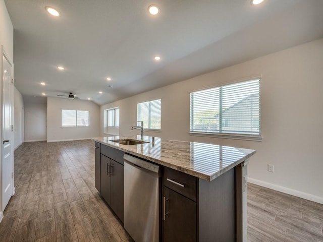 kitchen with wood finished floors, a sink, vaulted ceiling, stainless steel dishwasher, and open floor plan