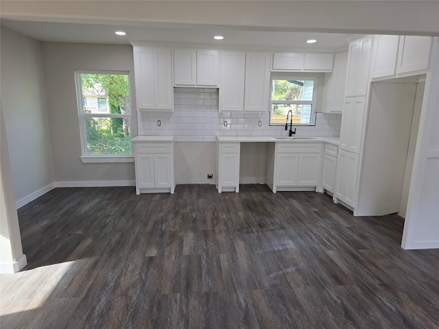 kitchen featuring white cabinetry, sink, backsplash, and dark hardwood / wood-style floors