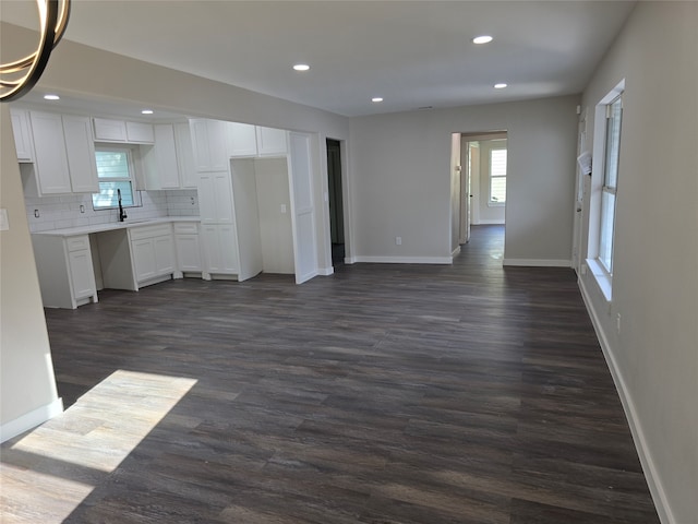 unfurnished living room featuring dark hardwood / wood-style flooring