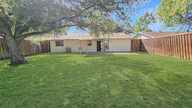 back of house with a patio area, a yard, and central AC unit