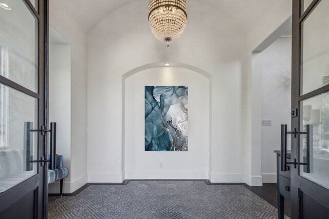 foyer entrance featuring french doors and a notable chandelier