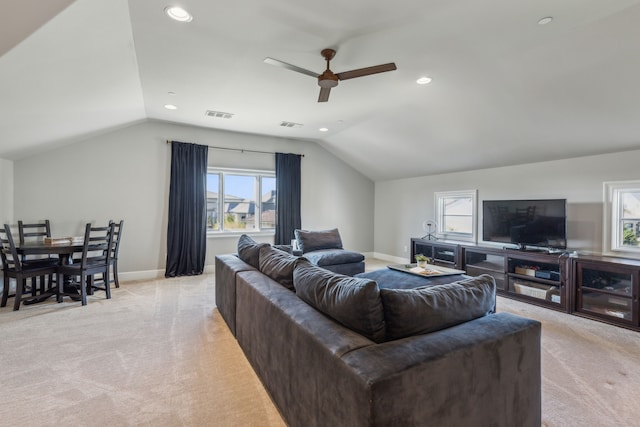 living room with light colored carpet, vaulted ceiling, and ceiling fan