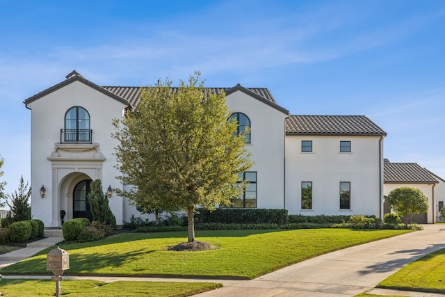 mediterranean / spanish-style home with a front yard