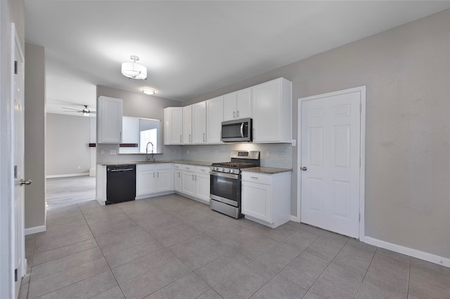 kitchen featuring sink, ceiling fan, appliances with stainless steel finishes, light tile patterned flooring, and white cabinetry