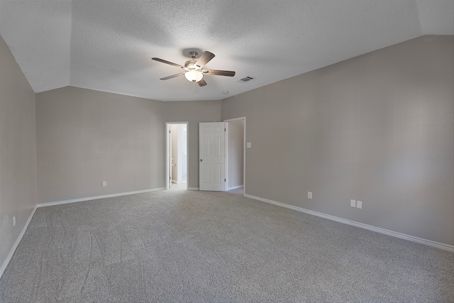 carpeted spare room featuring a textured ceiling, ceiling fan, and lofted ceiling