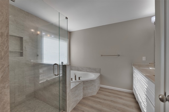 bathroom with vanity, hardwood / wood-style flooring, and independent shower and bath