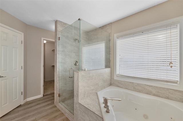 bathroom with wood-type flooring and separate shower and tub