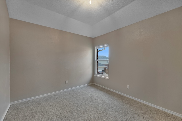 unfurnished room featuring carpet flooring and a textured ceiling