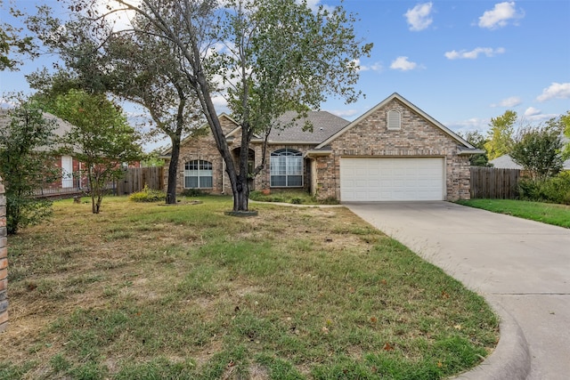 view of front of home featuring a front yard and a garage