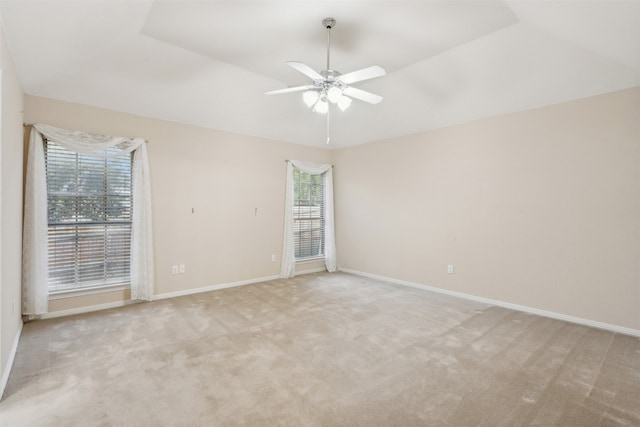 carpeted spare room featuring ceiling fan and vaulted ceiling