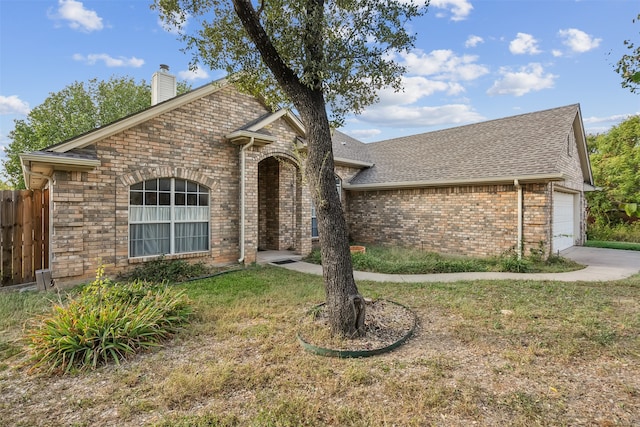 view of front of home with a front yard and a garage