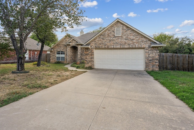 view of front of home featuring a front lawn and a garage