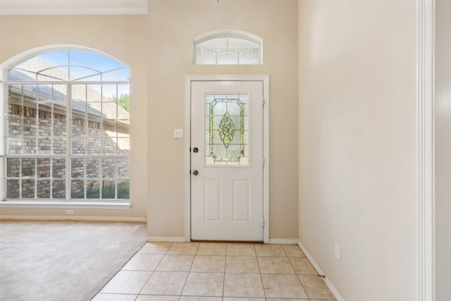 foyer with light tile patterned floors and a wealth of natural light