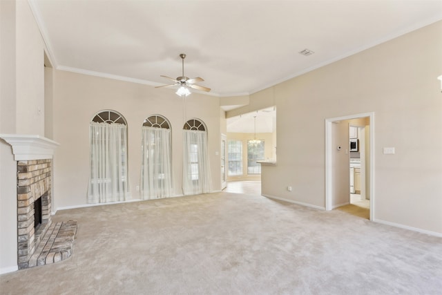 unfurnished living room with ornamental molding, ceiling fan, light colored carpet, and a brick fireplace