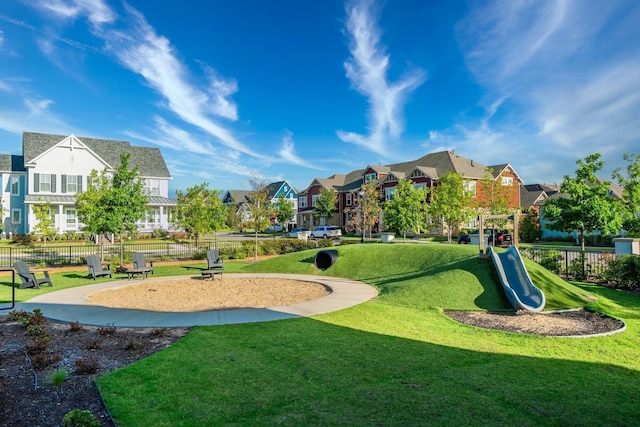 view of home's community featuring a lawn and a playground