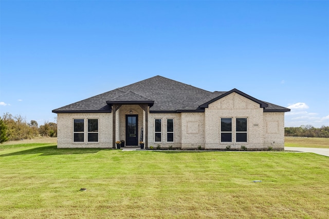 french country style house with a front lawn