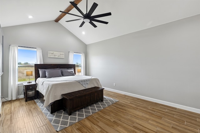 bedroom with ceiling fan, high vaulted ceiling, beam ceiling, and hardwood / wood-style floors