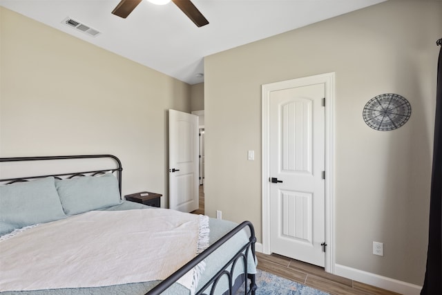 bedroom with hardwood / wood-style floors and ceiling fan