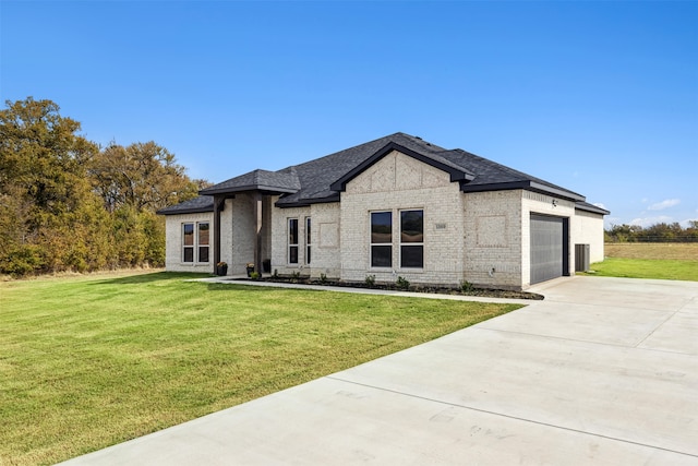 view of front of property with a front yard and a garage