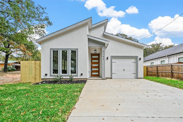 view of front of house featuring a front lawn and a garage