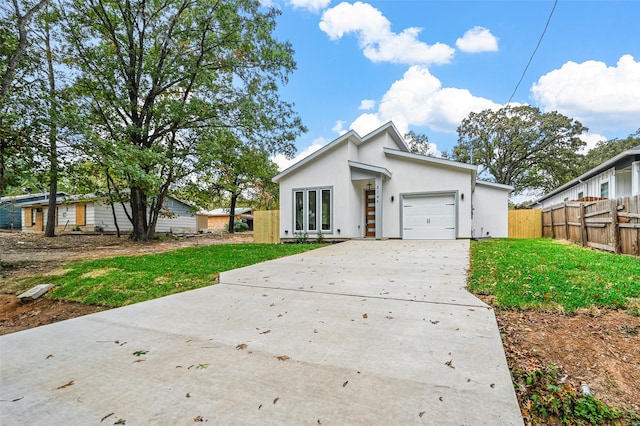 view of front facade with a front lawn and a garage