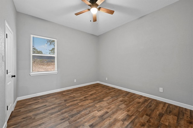 spare room with dark wood-type flooring and ceiling fan