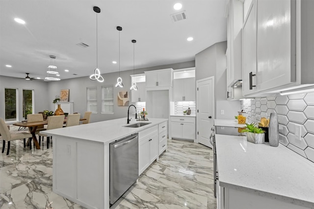 kitchen featuring a center island with sink, ceiling fan, white cabinetry, dishwasher, and sink