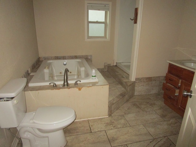 bathroom with vanity, a bath, and toilet