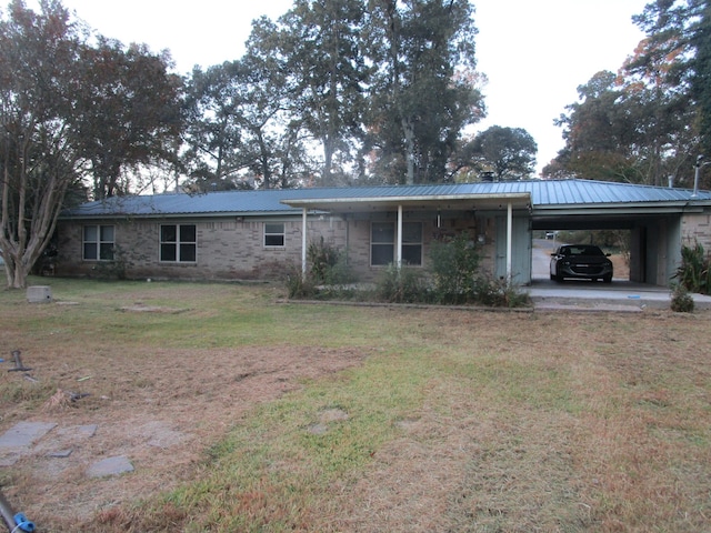 back of house with a carport and a lawn