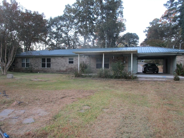 493 Lakeview Dr, Doyline, LA 71023 - rear view of house with metal roof, a lawn, and an attached carport