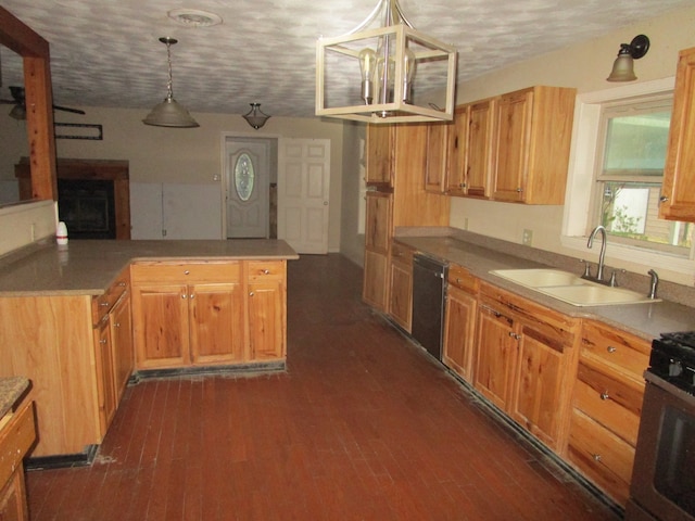 kitchen featuring black appliances, sink, a textured ceiling, pendant lighting, and dark hardwood / wood-style floors