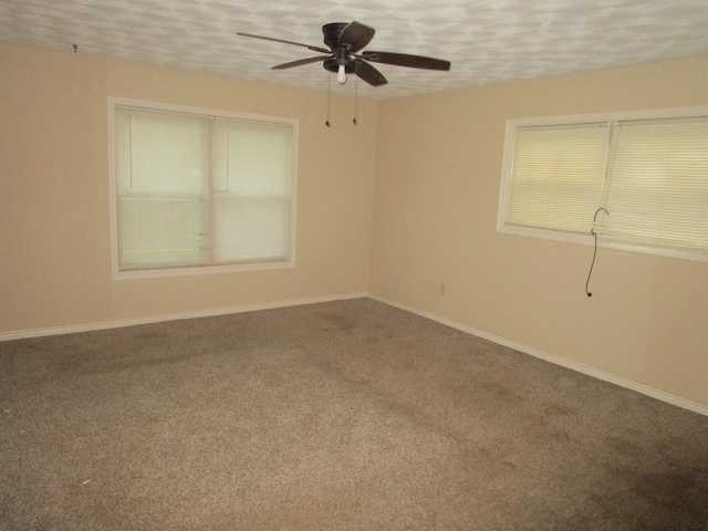 carpeted empty room featuring a textured ceiling and ceiling fan