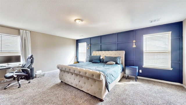 carpeted bedroom featuring a textured ceiling