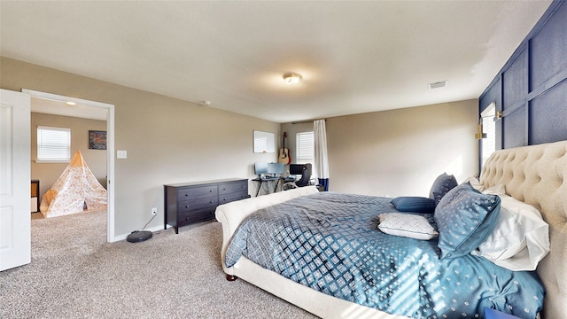 carpeted bedroom with multiple windows