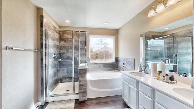 bathroom with vanity, hardwood / wood-style flooring, and independent shower and bath