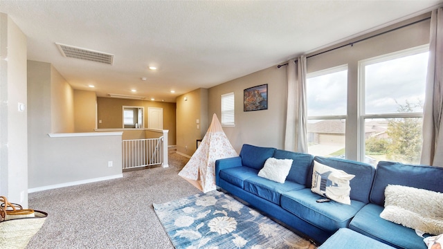 living room with a textured ceiling and carpet floors